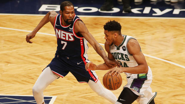 Milwaukee Bucks forward Giannis Antetokounmpo (34) dribbles the ball against Brooklyn Nets forward Kevin Durant.